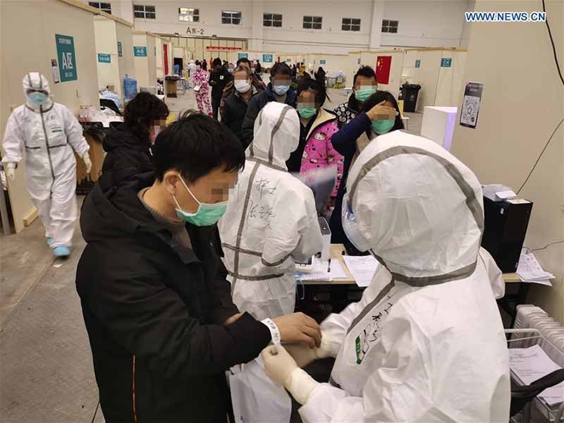 Des travailleurs médicaux soignent des patients au ? Salon de Wuhan ?