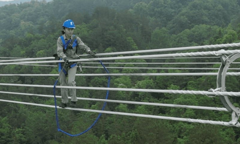 Hubei : une électricienne de 23 ans travaille en marchant sur une ligne UHV à 80 mètres du sol !