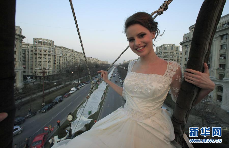 Le 20 mars, à Bucarest en Roumanie, une mannequin pose dans une montgolfière, vêtue d'une robe de mariée avec une tra?ne de 2750 mètres. Elle bat ainsi l'ancien record du monde établi à 2488 mètres.