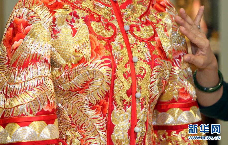 Une photo prise le 2 mars 2013 montrant une robe de mariée dessinée par Guo Pei présentée au magasin amiral ? Chinese Bride ? (? jeune mariée chinoise ?) au n ° 22 Waitan à Shanghai, dans l'Est de la Chine. Un défilé de robes de mariages a été organisé par Guo Pei, la propriétaire du magasin amiral de ? Chinese Bride? et aussi styliste de premier plan, qui a créé des robes de cérémonie à la fois pour le Gala de la Fête du Printemps de CCTV et les Jeux Olympiques de Beijing en 2008. [Photo / Xinhua]