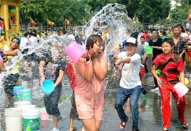 Une femme aspergée d'eau lors des célébrations de la Fête de l'eau dans la préfecture autonome Dai et Jingpo de Dehong, dans le Yunnan, le 11 avril 2013. [Photo / Xinhua]