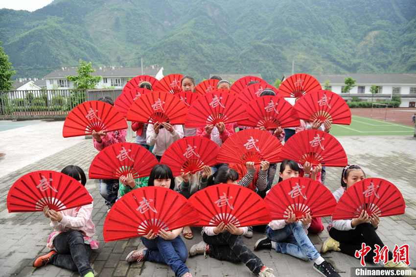 Le 8 mai 2013, des enfants suivent un cours de danse dans une école à Mianzhu。(Photo : Liu Zhongjun)