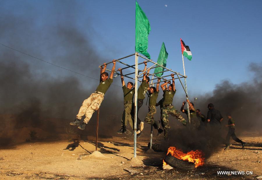 Des gar?ons palestiniens participent à un exercice militaire lors d'une cérémonie de fin d'études d'une école militaire organisée par le hamas dans la ville de Rafah, dans le sud de Gaza, le 19 juin 2013. (Xinhua/Khaled Omar)