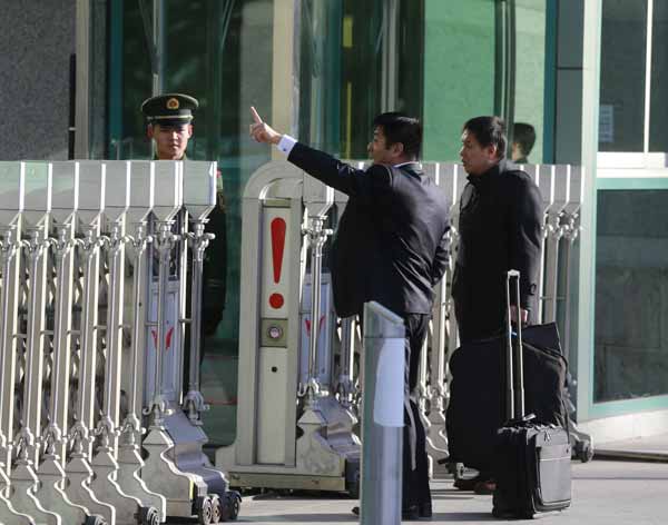 Zhang Qihuai, l'avocat du jeune Li, qui a déposé un recours devant la Cour populaire intermédiaire No 1 de Beijing, salue le public en arrivant au tribunal le 19 novembre 2013. [Photo Feng Yongbin / Asianewsphoto]